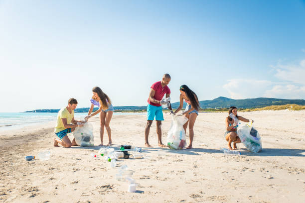 istock Volunteers collecting plastic on the beach 1166778088