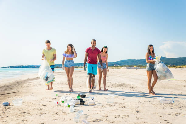 istock Volunteers collecting plastic on the beach 1166778100