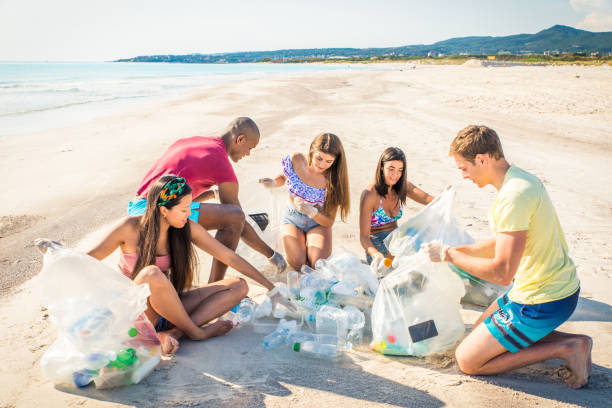 istock Volunteers collecting plastic on the beach 1166778107
