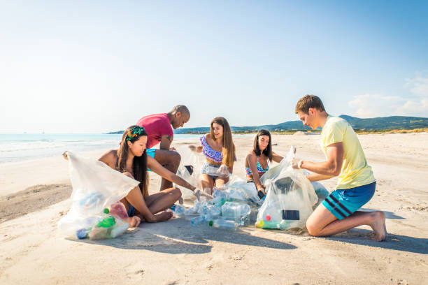 istock Volunteers collecting plastic on the beach 1166778617
