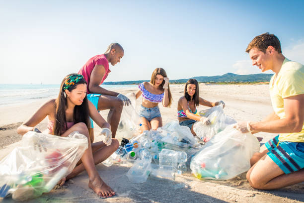 istock Volunteers collecting plastic on the beach 1166778648