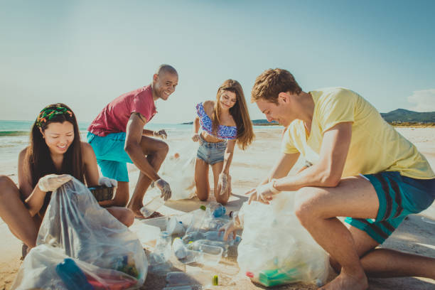 istock Volunteers collecting plastic on the beach 1166778688
