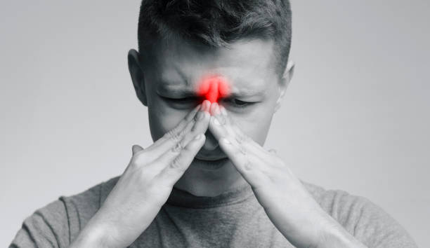 istock Frustrated young man suffering from sinus pressure 1166778924