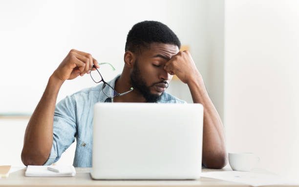 istock Tired african worker taking his glasses off 1166779873