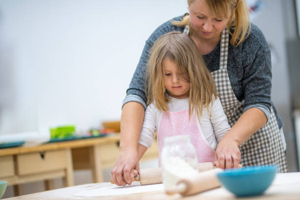 istock Girl making pizza in cooking class 1166780540