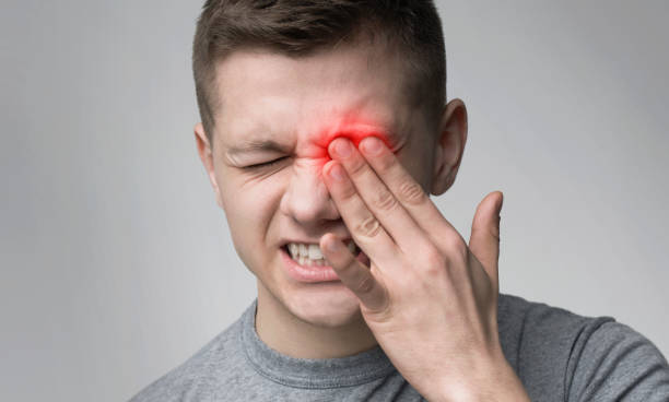 Upset man suffering from strong eye pain Upset man suffering from strong eye pain. Healthcare concept, panorama touch sensitive stock pictures, royalty-free photos & images