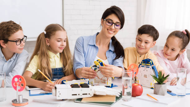 istock Kids working with teacher on robot project 1166781940
