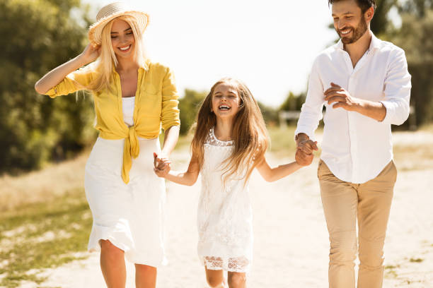 istock Happy parents walking with daughter, holding hands 1166782185