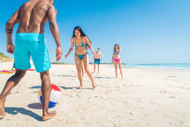 istock Friends having fun on the beach 1166782586