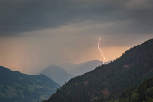 Lightning strike in the mountains of Tirol, Austria at sunset.