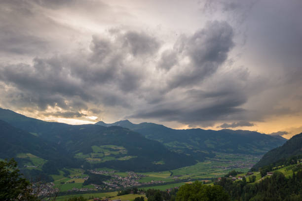 Beautiful view over Zillertal valley, Austria with stormy clouds over the mountains.