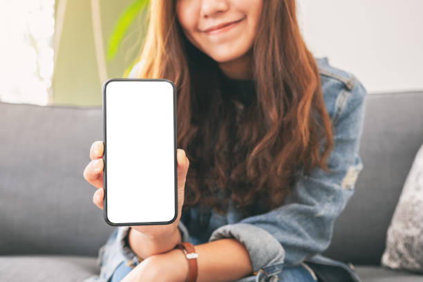 istock a woman holding and showing black mobile phone with blank screen 1166782741