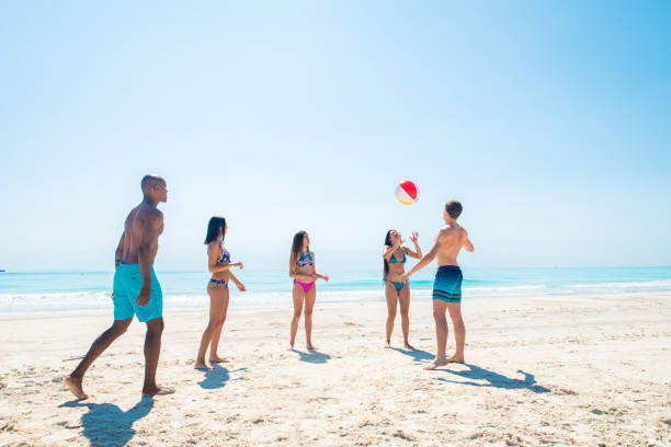istock Friends having fun on the beach 1166782760