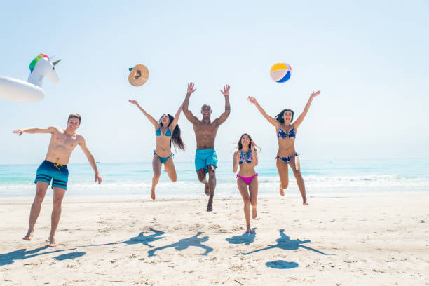 istock Friends having fun on the beach 1166784105