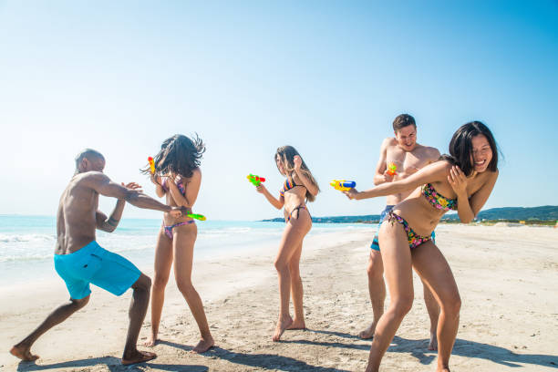 istock Friends having fun on the beach 1166784948