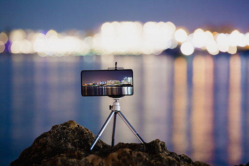 Using smartphone on tripod and long exposure to making the photo of beautiful sea night landscape