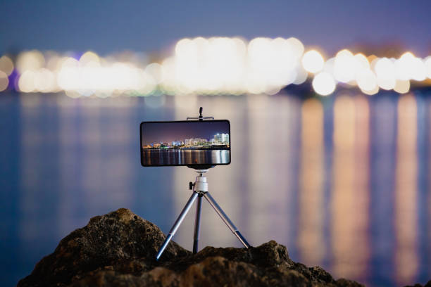 Using smartphone on tripod to making the photo of night landscape stock photo