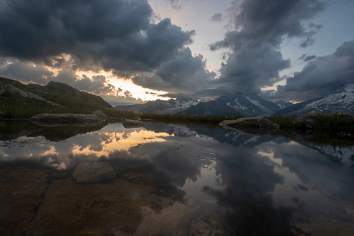 Monte Bianco mountain range reflected in a pond at Sunset - France