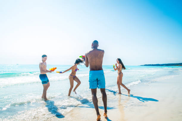 istock Friends having fun on the beach 1166785440