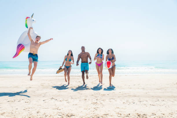 istock Friends having fun on the beach 1166786191