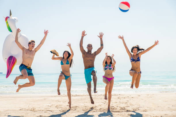 istock Friends having fun on the beach 1166786323