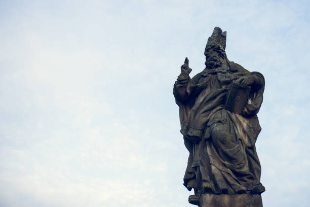 istock St. Adalbert statue on Charles Bridge in Prague, Czech Republic. Medieval Gothic bridge, finished in the 15th century, crossing the Vltava River 1166786911