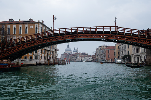 Venice, Italy - February 21, 2022: Looking out across the magnificent Grand Canal in Venice from the iconic Rialto Bridge.