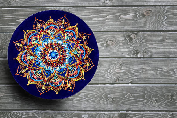 istock Decorative ceramic plates hand painted dot pattern with acrylic paints on a gray wooden background. Copy space. 1166787928