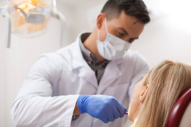 istock Young male dentist working at his clinic 1166788239