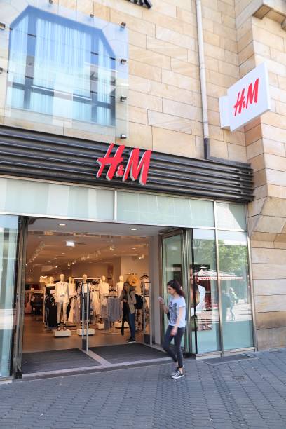 H&M fashion store People visit H&M fashion store at Karolinenstrasse shopping street in Nuremberg, Germany. karolinenstrasse stock pictures, royalty-free photos & images