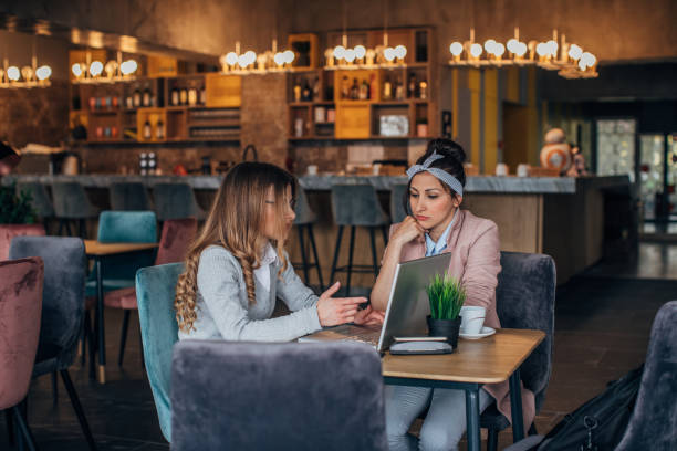 istock Two women sitting in cafe 1166789881