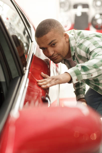 istock Handsome African man buying new car 1166789982