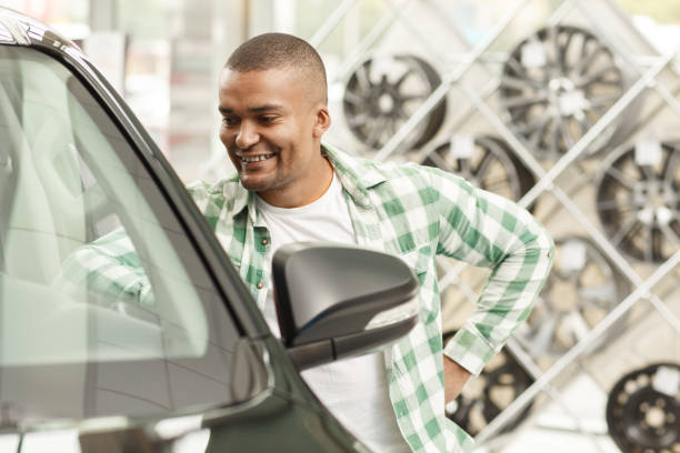 istock Handsome African man buying new car 1166790835