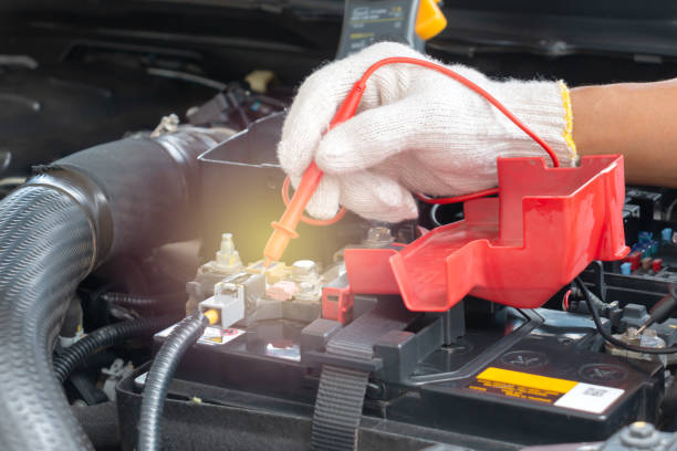 istock Mechanic car service using Multimeter to check the voltage level in a car battery 1166791027