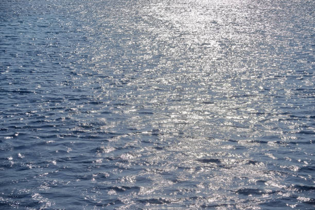 istock Blue sea water and white sunlight reflection, ripple surface background 1166801162