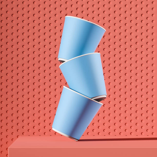 pila di tazze di carta blu che cadono sul tavolo rosa - disposable cup cup stack blue foto e immagini stock