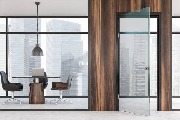 istock Dark wooden coworking office with open door 1166803334