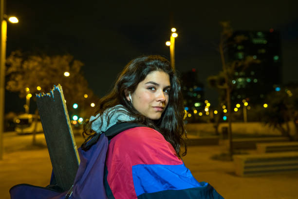 Young girl carrying her broken skateboard after an accident