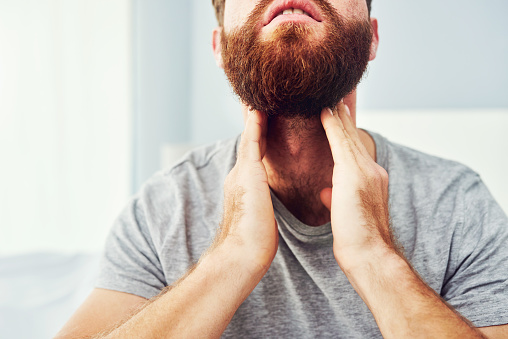 Cropped shot of an unrecognizable man suffering with a sore throat