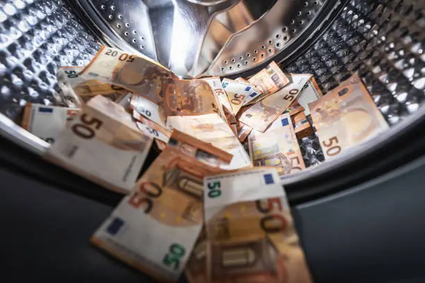 Photo of money laundering concept - euro banknotes in washing machine