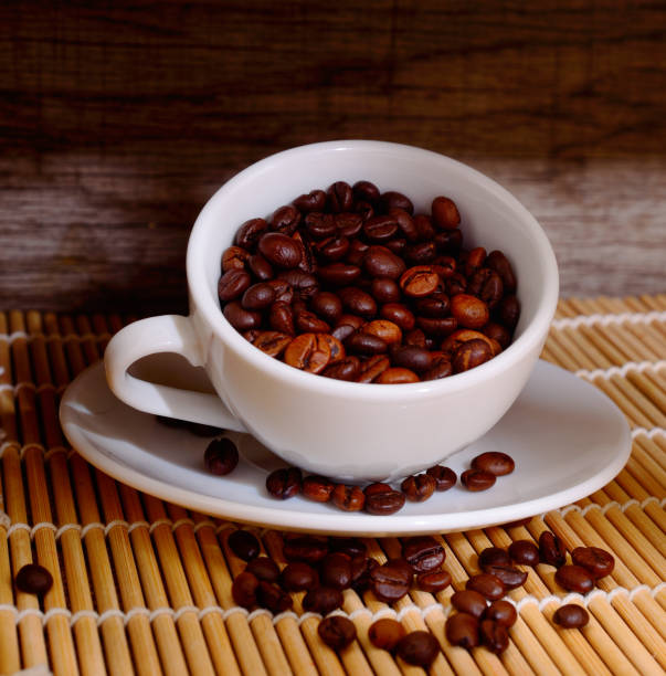 istock White cup of coffee with coffee beans. 1166803853