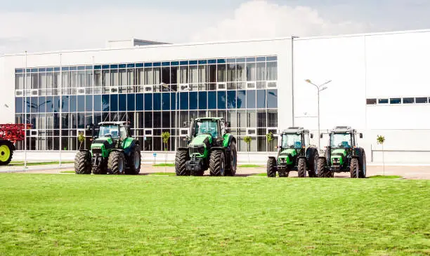Photo of new tractors are standing next to the trading pavilion for sale in Kiev region, Ukraine