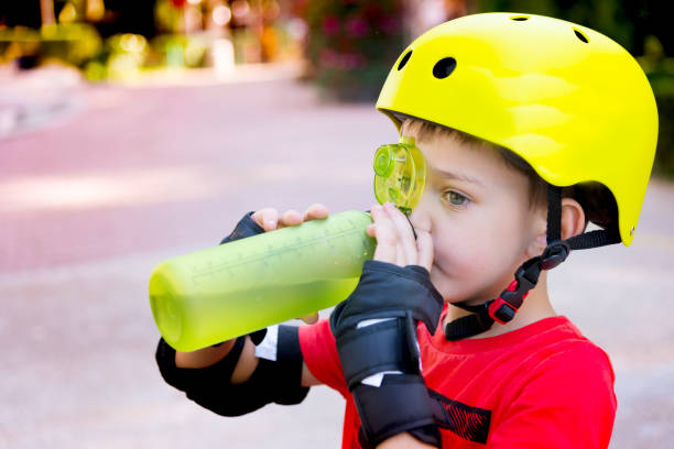 istock Child with roller skate helmet, drink a water. 1166803898