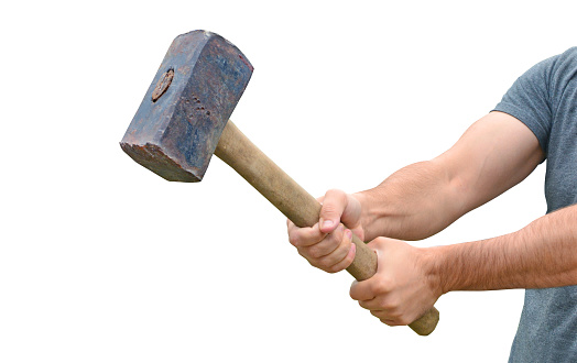 Hit and destroy concept. Strong man's hands with a sledgehammer isolated on white.