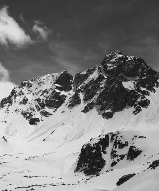 istock Black and white snowy mountains with traces from avalanche 1166807274