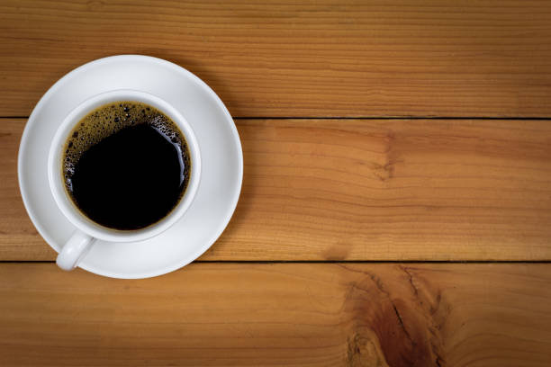 istock Cup of coffee on wood background, top view. 1166811303