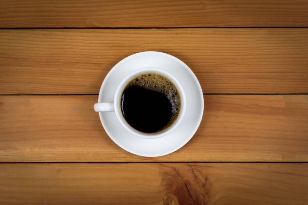 istock Cup of coffee on wood background, top view. 1166811355