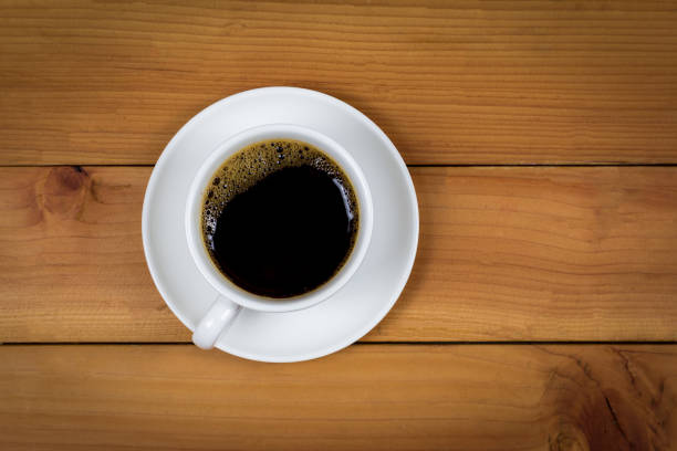 istock Cup of coffee on wood background, top view. 1166811370