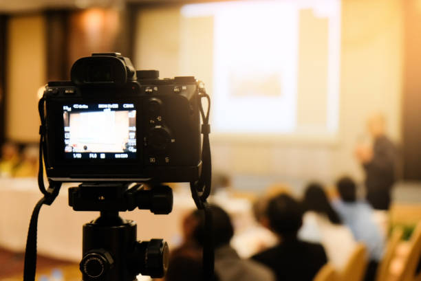 istock camera in business conference room recording participants and speaker echnology transformation of mirrorless camera. 1166812651