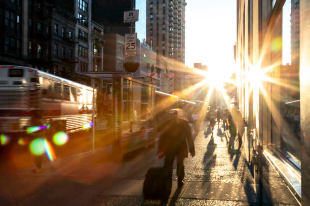 istock Man walking down the sidewalk in New York City with bright sunlight background 1166812850